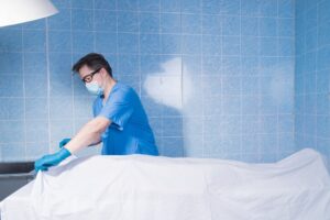 coroner inspecting a body