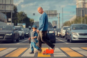 man walking son through intersection