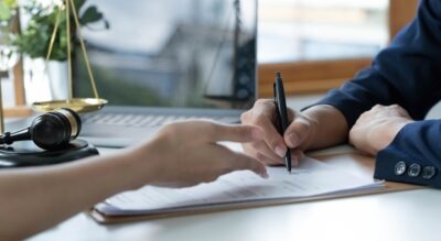 Client signing a settlement agreement scaled