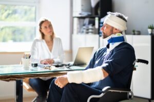 Injured man in wheelchair talks to Georgia workers' comp lawyer after Costco accident