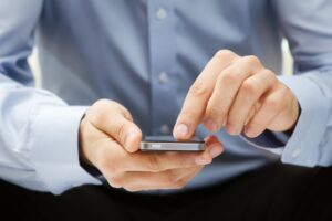 A man on his cellphone wonders if it is normal not to hear from his lawyer.