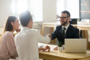 A lawyer smiles with his clients. Learn how a good lawyer makes a difference.