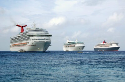 Which Cruise Line has had the Most Deaths? | John Foy & Ass. Giant cruise ships at a busy port. Which cruise line has had the most deaths?