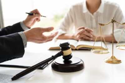 Lawyer sits with client at desk and provides a Sterigenics lawsuit update.