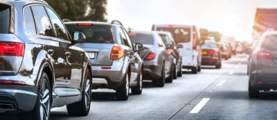 Cars on a highway in a traffic jam. Does workers' compensation cover travel to and from work?