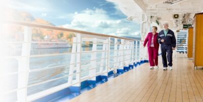 Man and woman walking on a cruise ship, with both people understanding negligent security on cruise ship and taking the appropriate measures to remain safe while they are traveling.