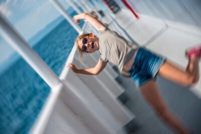 Most Common Cruise Ship Injuries | John Foy & Associates A woman slipping on a cruise ship, which is one of the most common cruise ship injuries.
