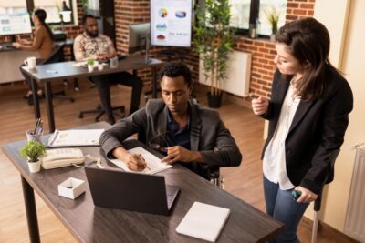 What Is a Workers' Compensation Hearing? | Lawyer 24/7 Businesswoman on crutches talking to colleague. What is a workers' compensation hearing?