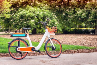 An electric bicycle supported by its kickstand to symbolize the question of, “What are the most common injuries from e-bikes?”