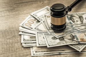 What Are the Pros & Cons of a Lump Sum Workers’ Comp Settlement?