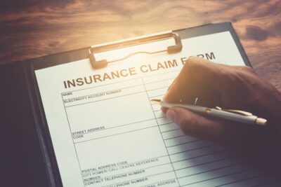 An insurance claim form, with someone filling out the form wondering how long an insurance company has to investigate a claim